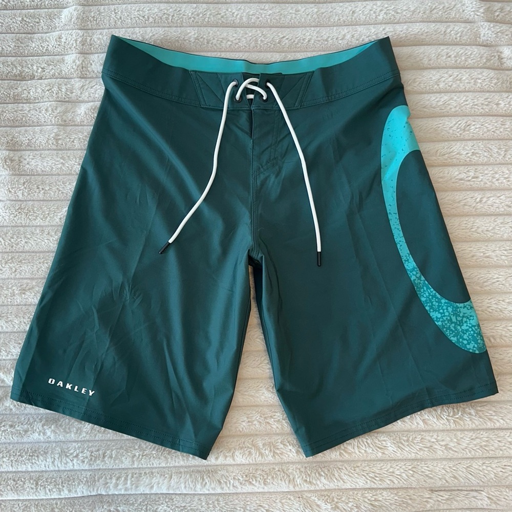 Oakley board shorts, teal blue. Performance fit, new condition, unworn.